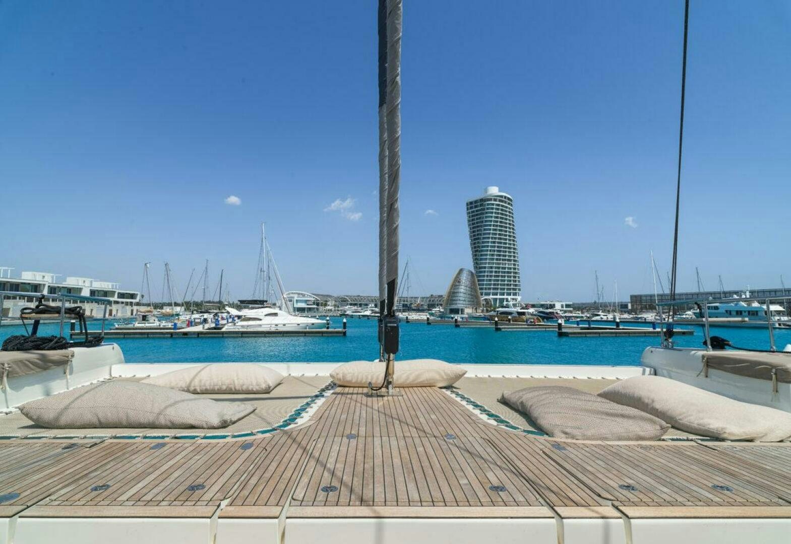 a dock with boats and buildings in the background aboard OV Yacht for Sale
