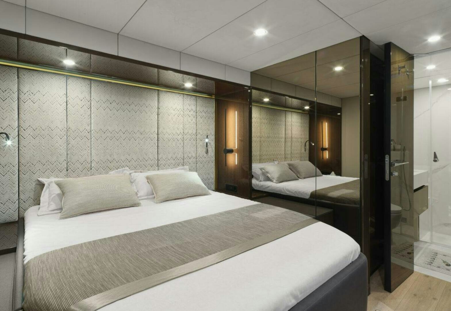 a room with a couple of beds aboard OV Yacht for Sale