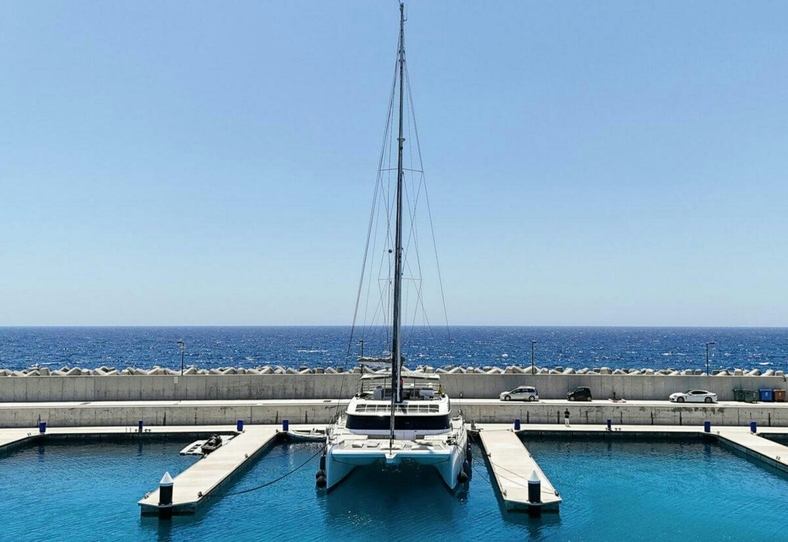a boat is parked at a dock aboard OV Yacht for Sale