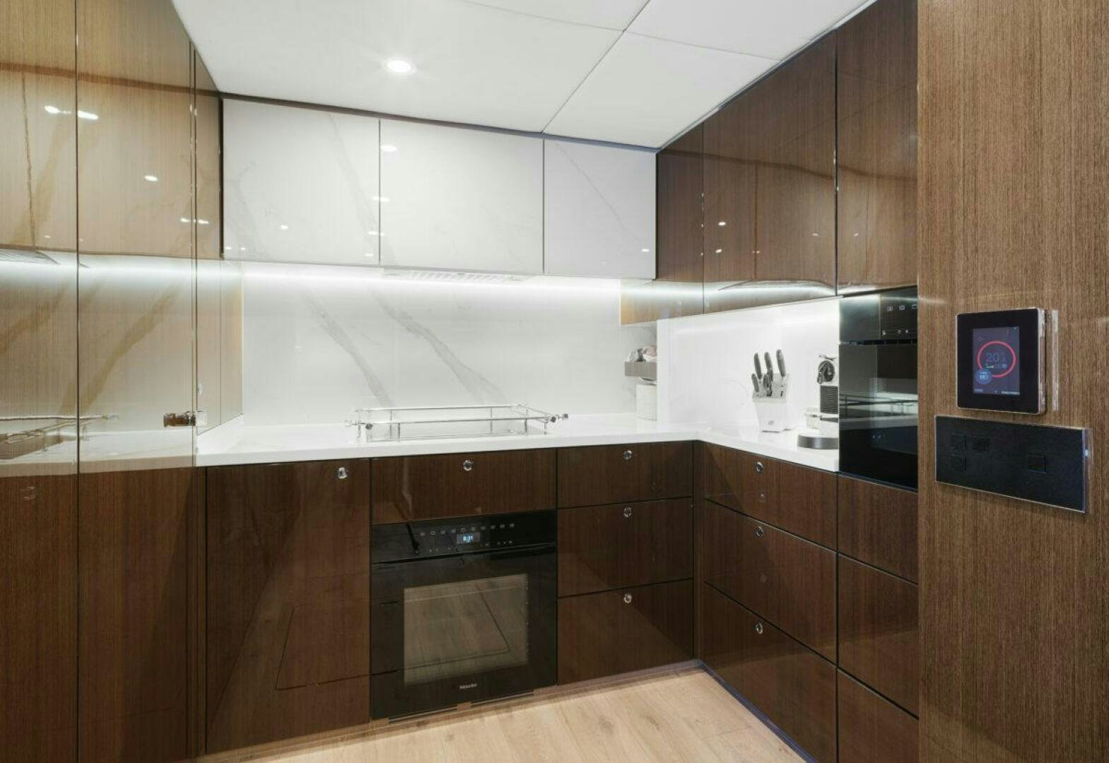 a kitchen with wooden cabinets aboard OV Yacht for Sale