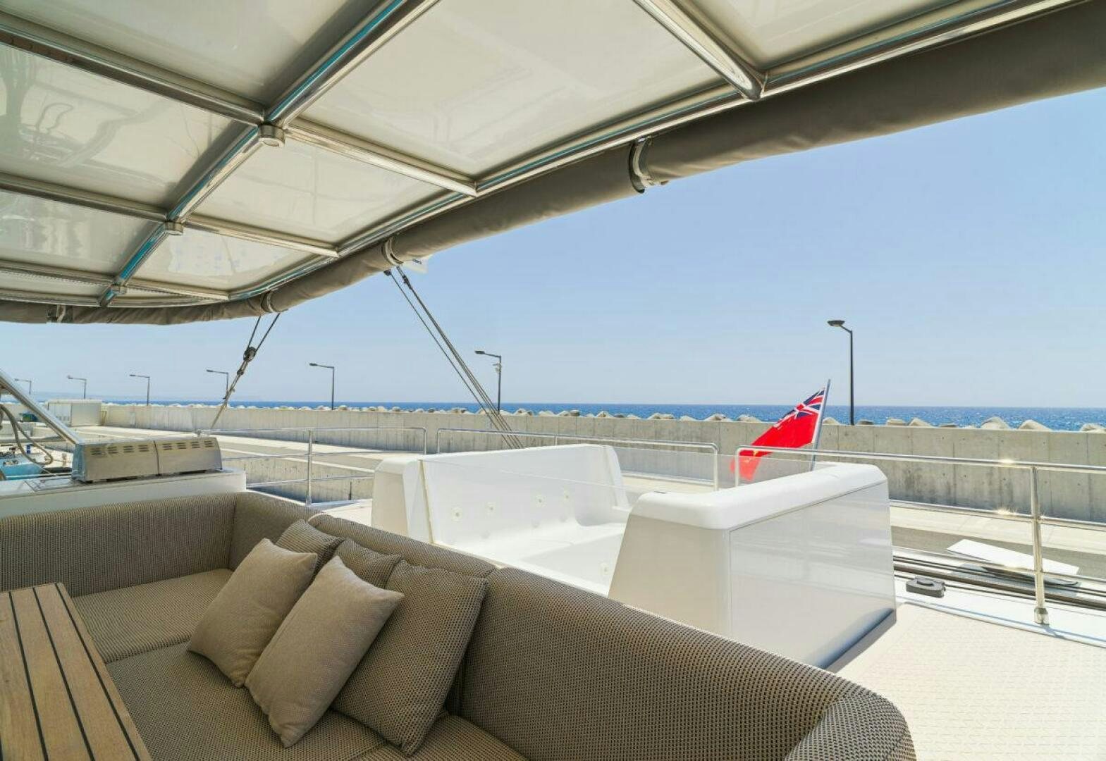 a large room with couches and a flag aboard OV Yacht for Sale