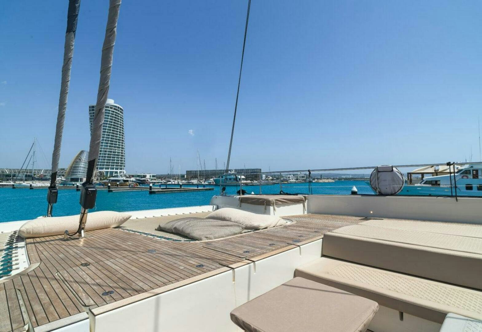a deck with a view of a city and water aboard OV Yacht for Sale
