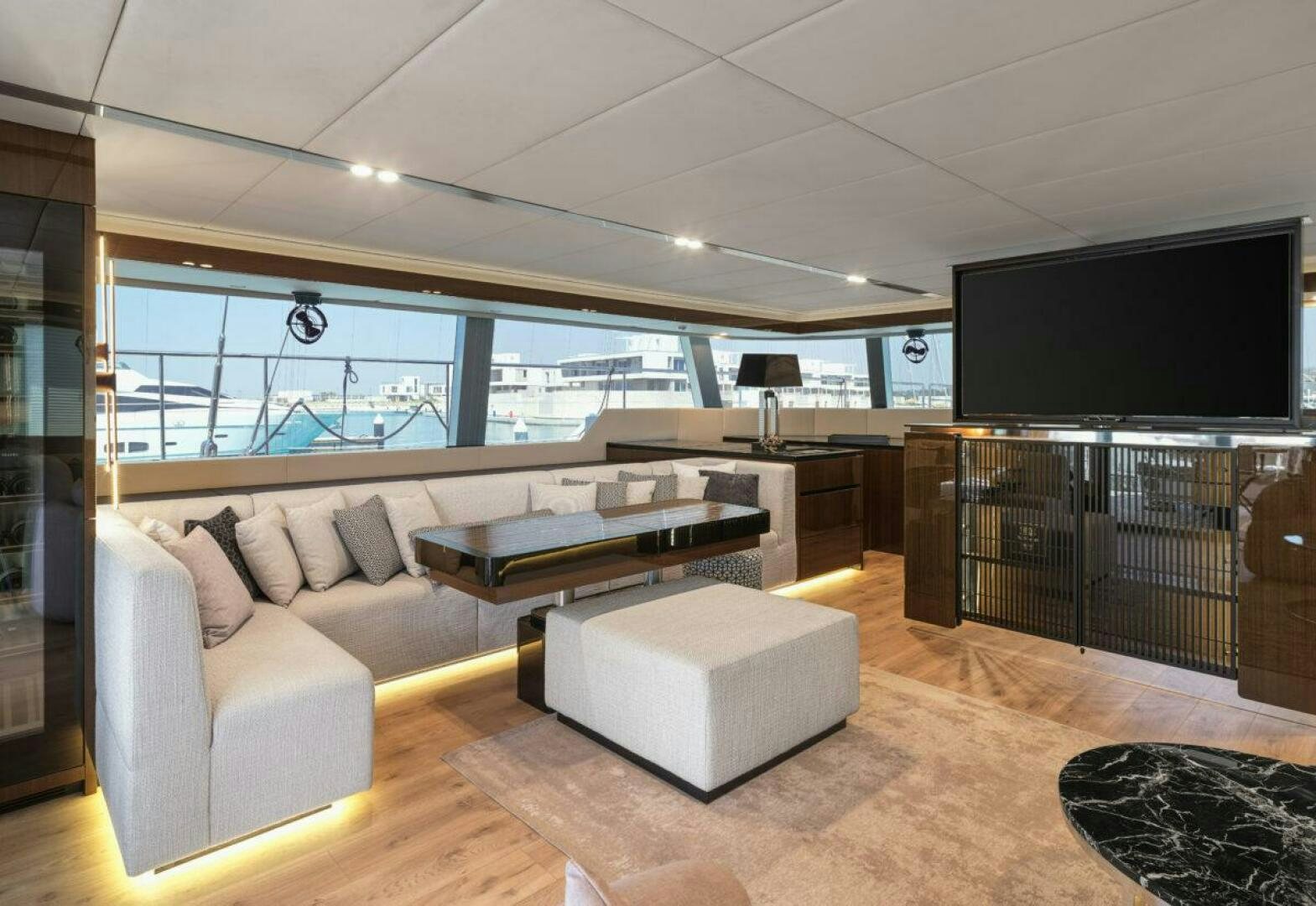 a living room with a large screen aboard OV Yacht for Sale