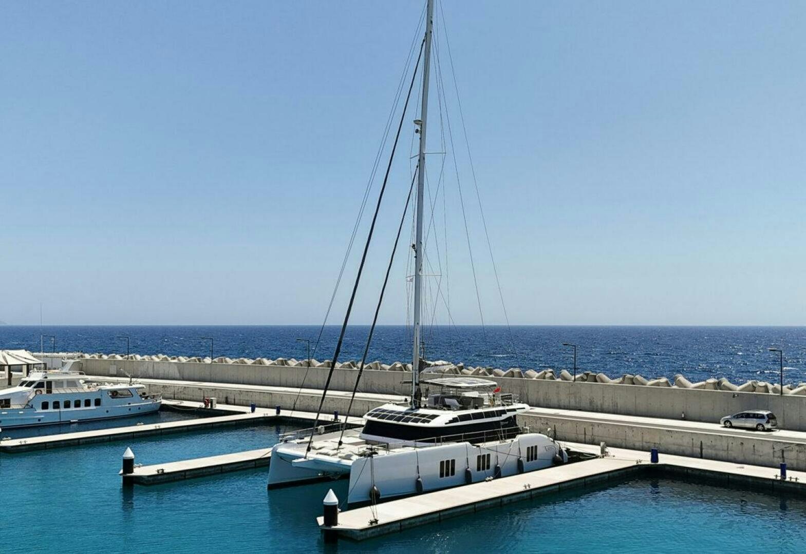 a sailboat docked at a pier aboard OV Yacht for Sale