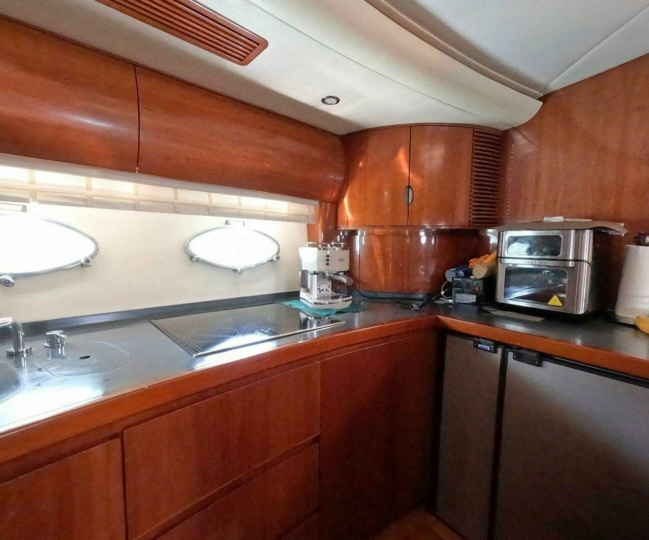 a kitchen with wooden cabinets aboard INCENTIVE Yacht for Sale