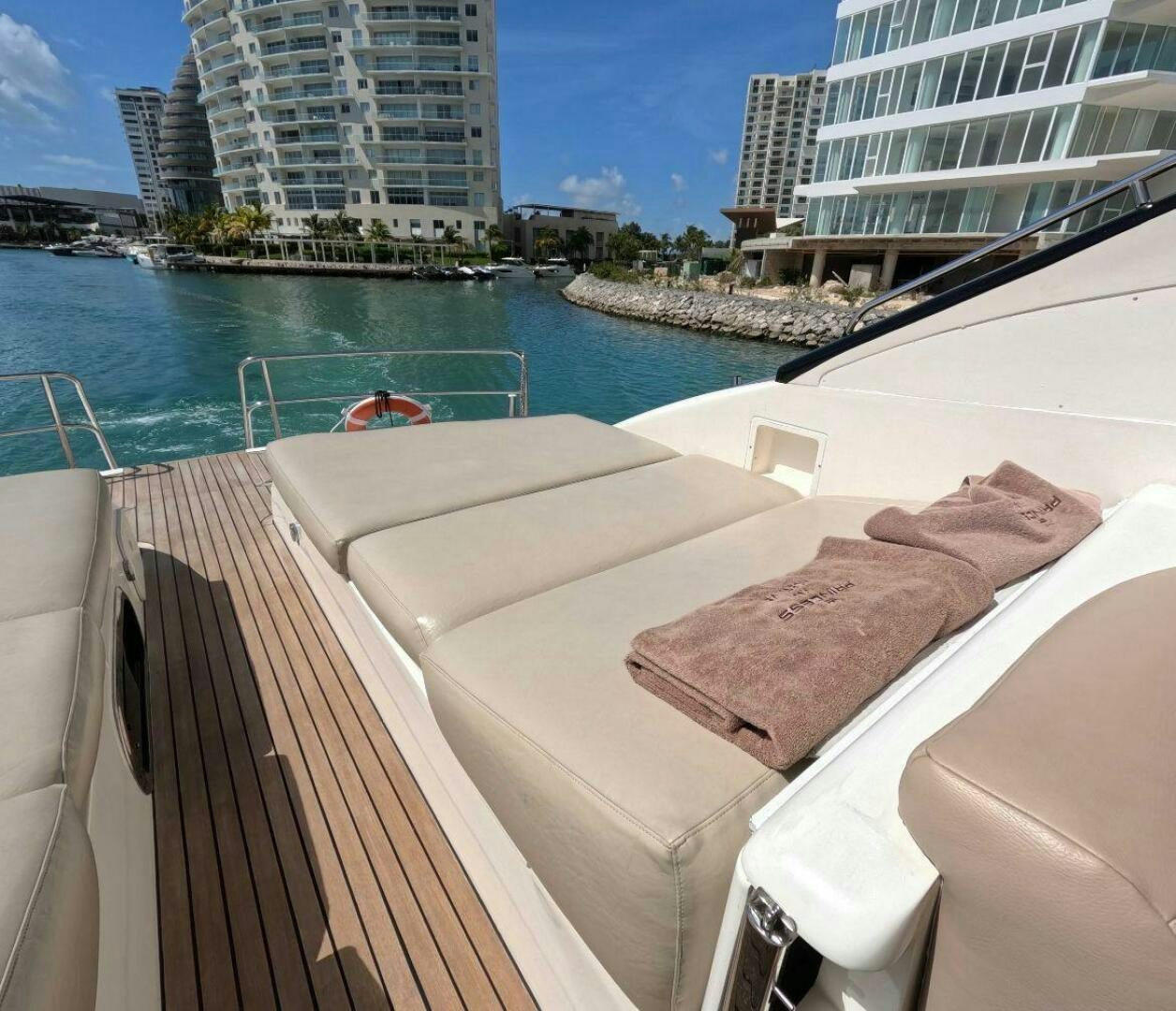 a deck with a towel on it and a body of water in the background aboard INCENTIVE Yacht for Sale
