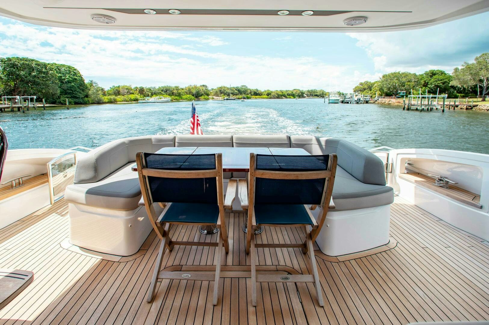 a table and chairs on a deck overlooking a body of water aboard RIPPLE Yacht for Sale
