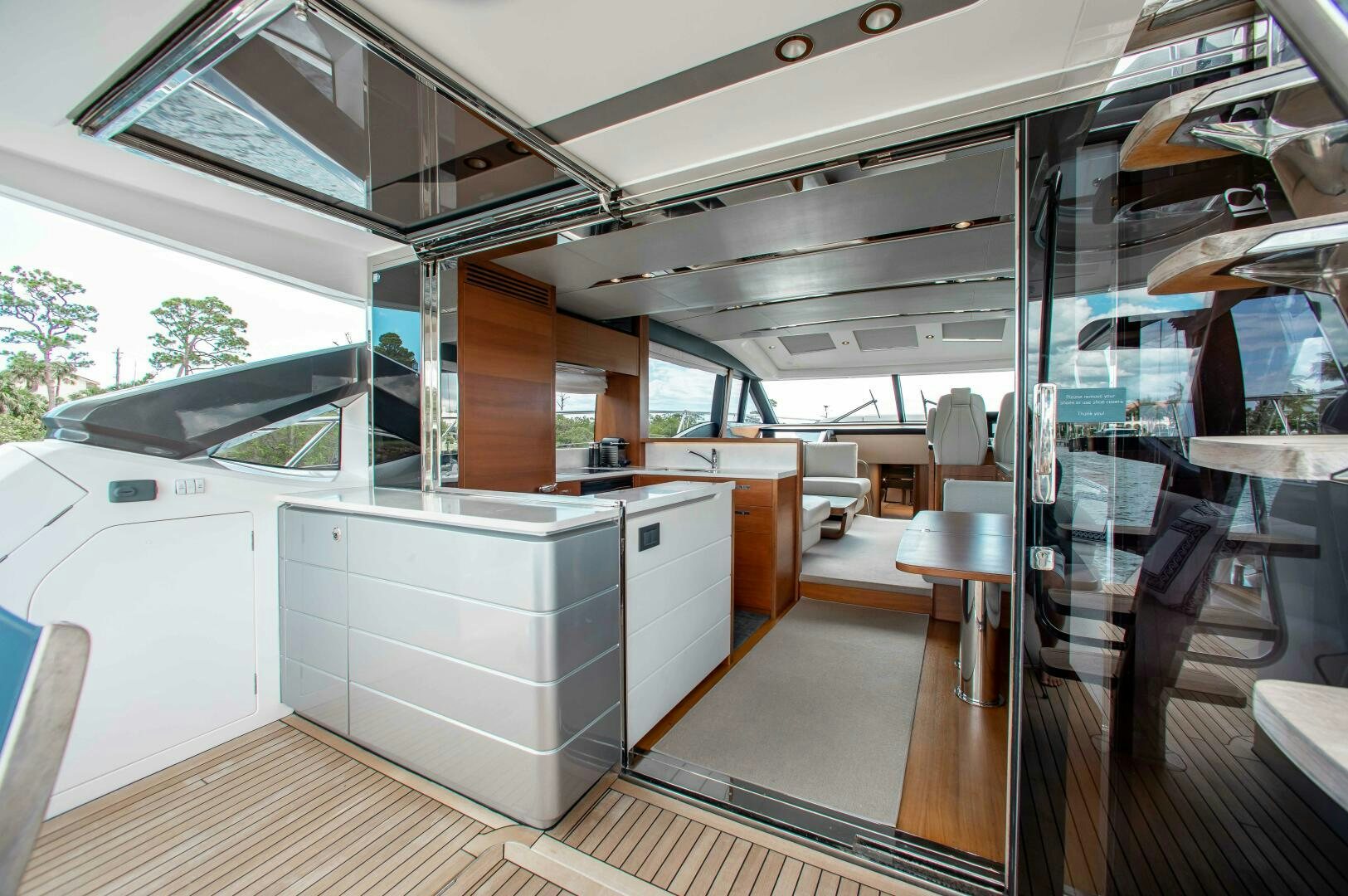 a room with a large window and a table with chairs aboard RIPPLE Yacht for Sale