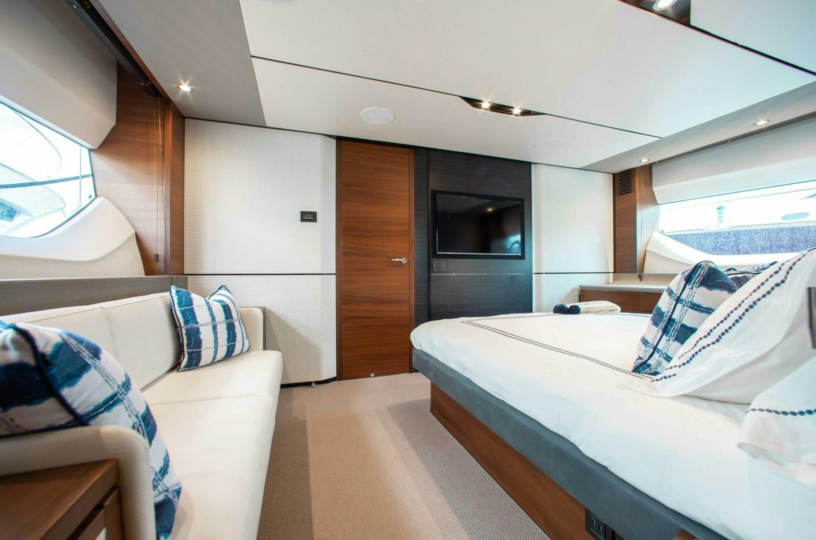 a room with a bed and a television aboard RIPPLE Yacht for Sale