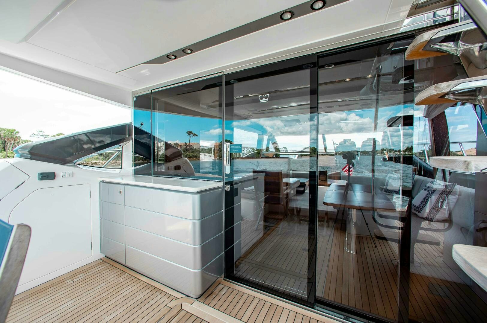 a room with glass walls and a sliding door aboard RIPPLE Yacht for Sale