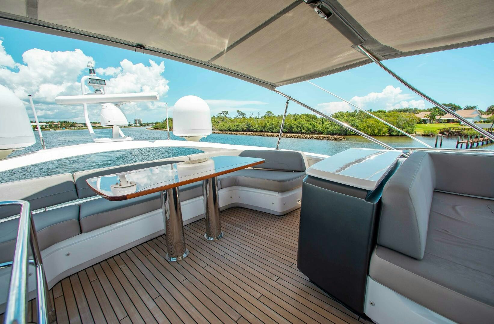 a deck with a table and chairs aboard RIPPLE Yacht for Sale