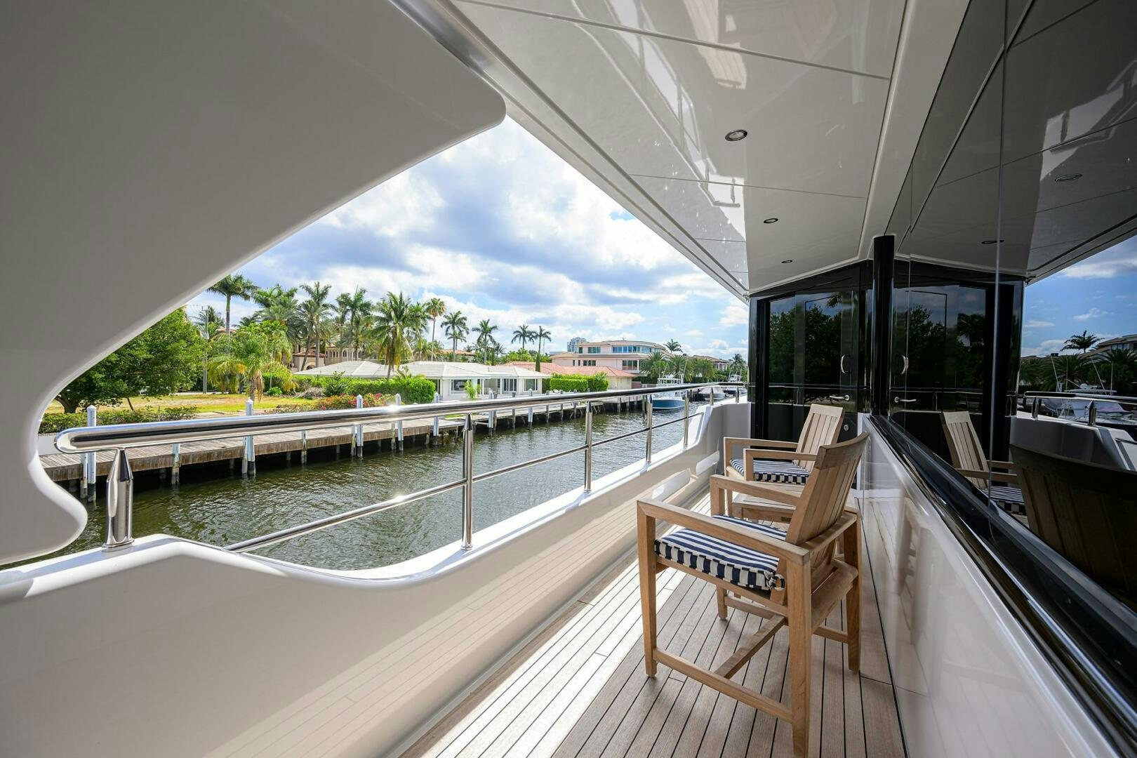 a deck with a view of the beach and the ocean aboard NEENAH Yacht for Sale