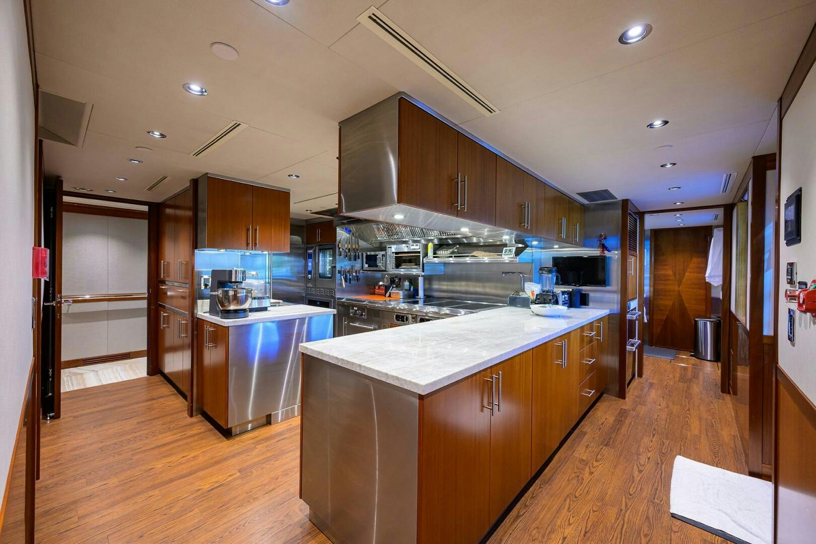 a kitchen with wooden cabinets aboard NEENAH Yacht for Sale