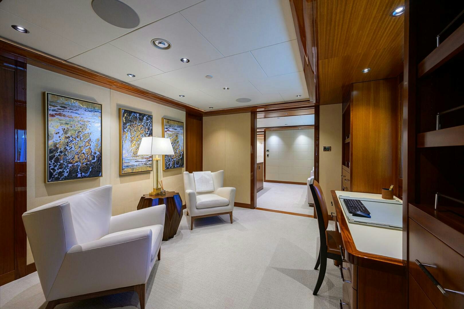 a room with a table chairs and a lamp aboard NEENAH Yacht for Sale