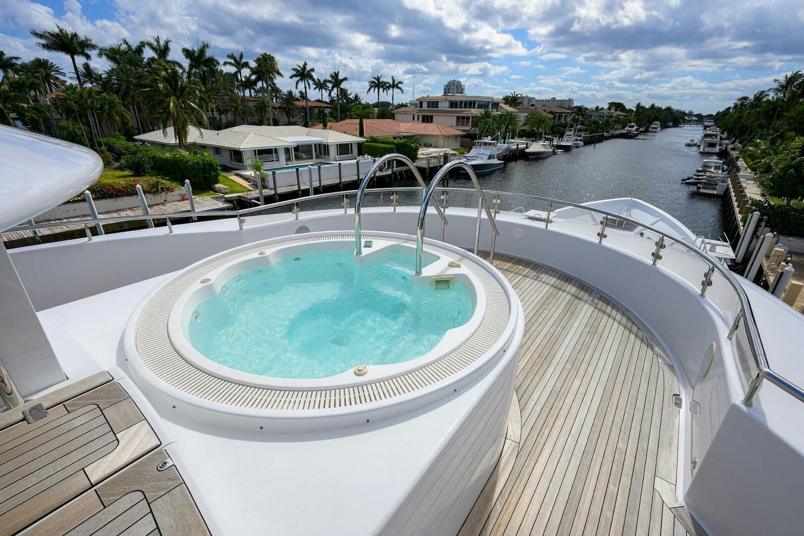a swimming pool with a building in the background aboard NEENAH Yacht for Sale