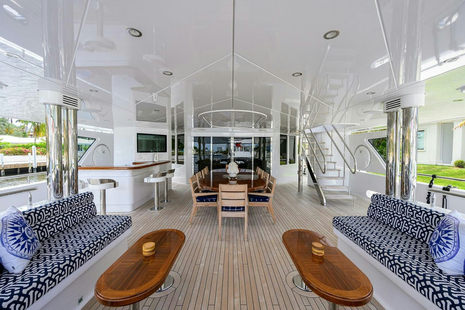 a large living room with a wood table and chairs aboard NEENAH Yacht for Sale