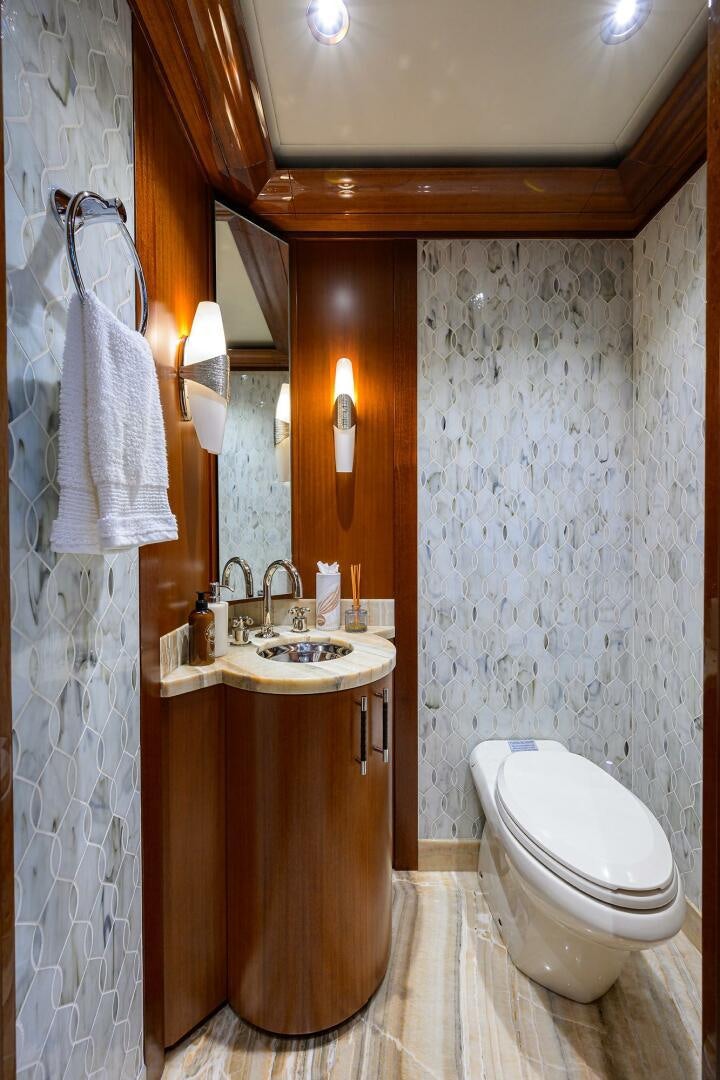 a bathroom with a sink toilet and a mirror aboard NEENAH Yacht for Sale