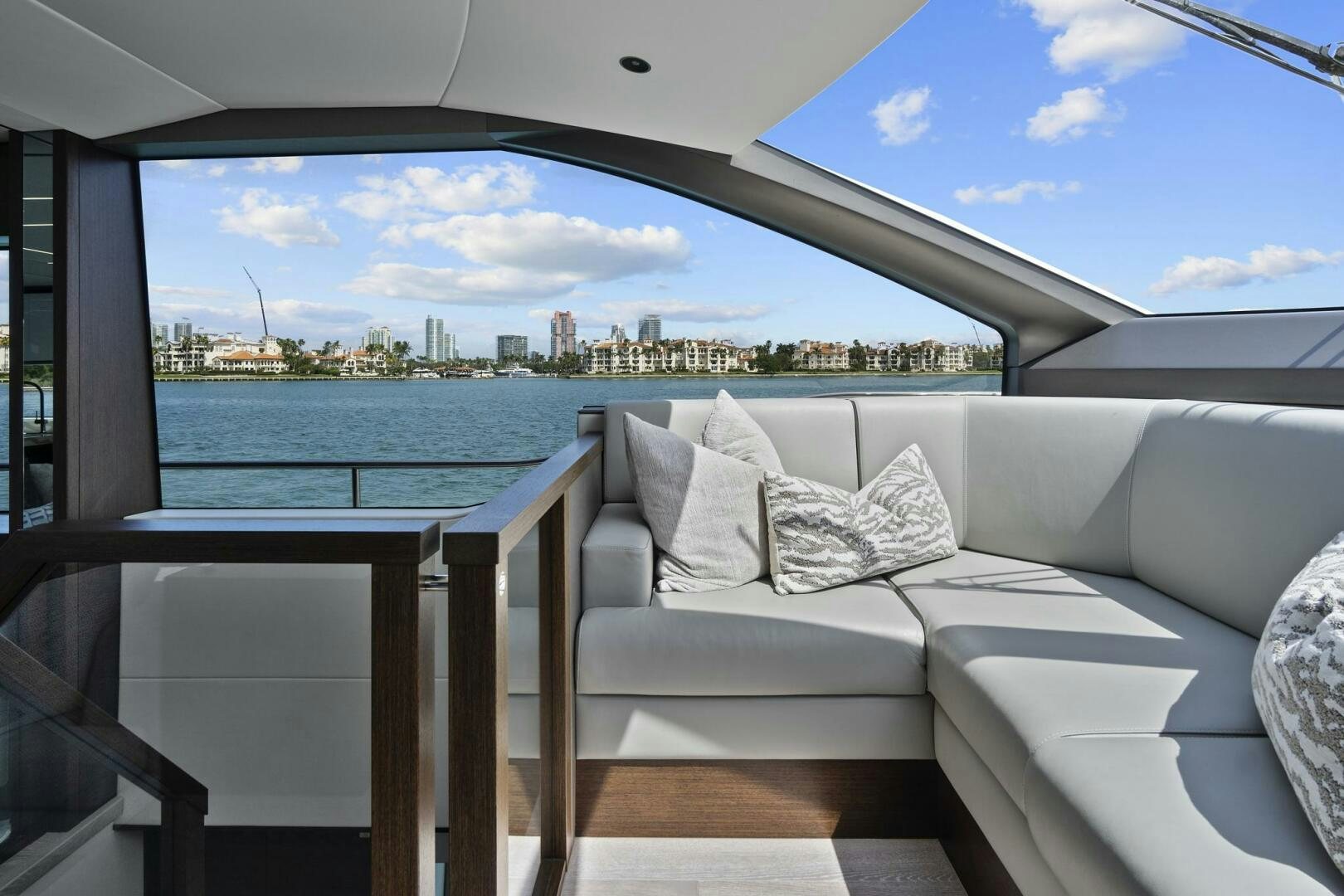 a white couch on a balcony overlooking a body of water aboard SEA ONE Yacht for Sale