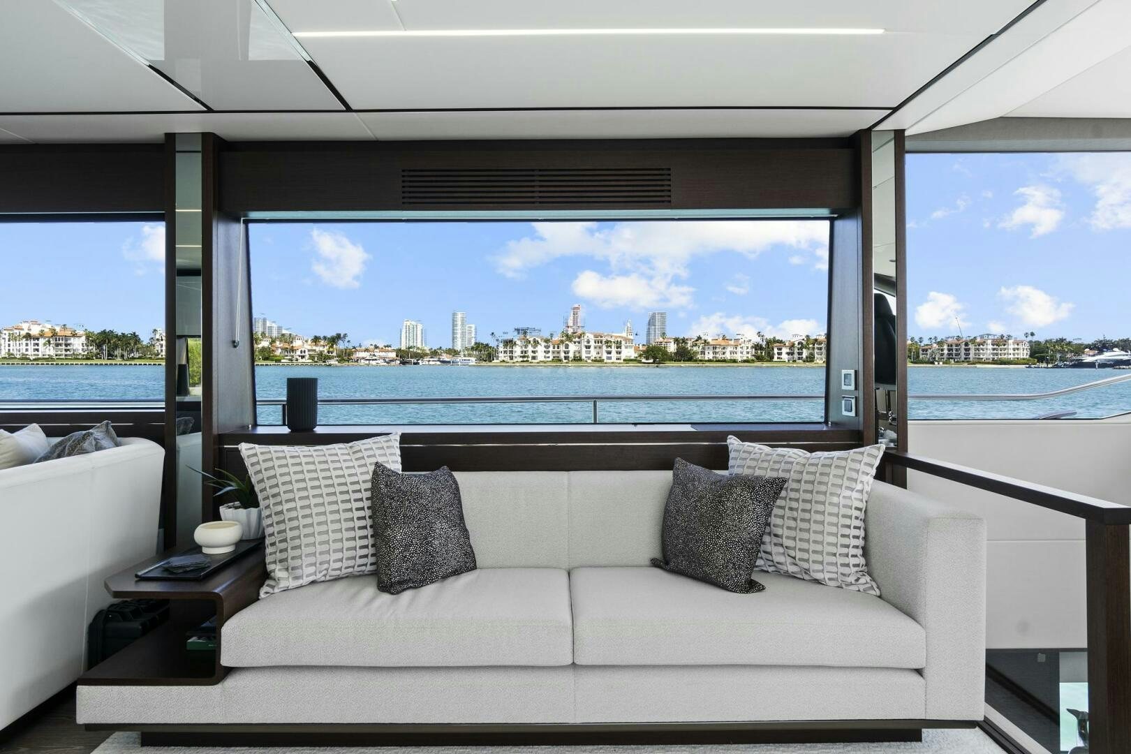 a couch and a window in a room aboard SEA ONE Yacht for Sale