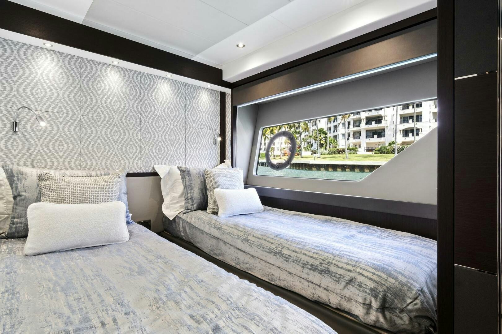 a bed with a large window aboard SEA ONE Yacht for Sale