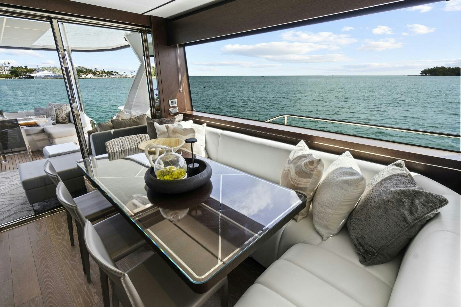 a table with a bowl of fruit on it on a balcony overlooking a body of water aboard SEA ONE Yacht for Sale