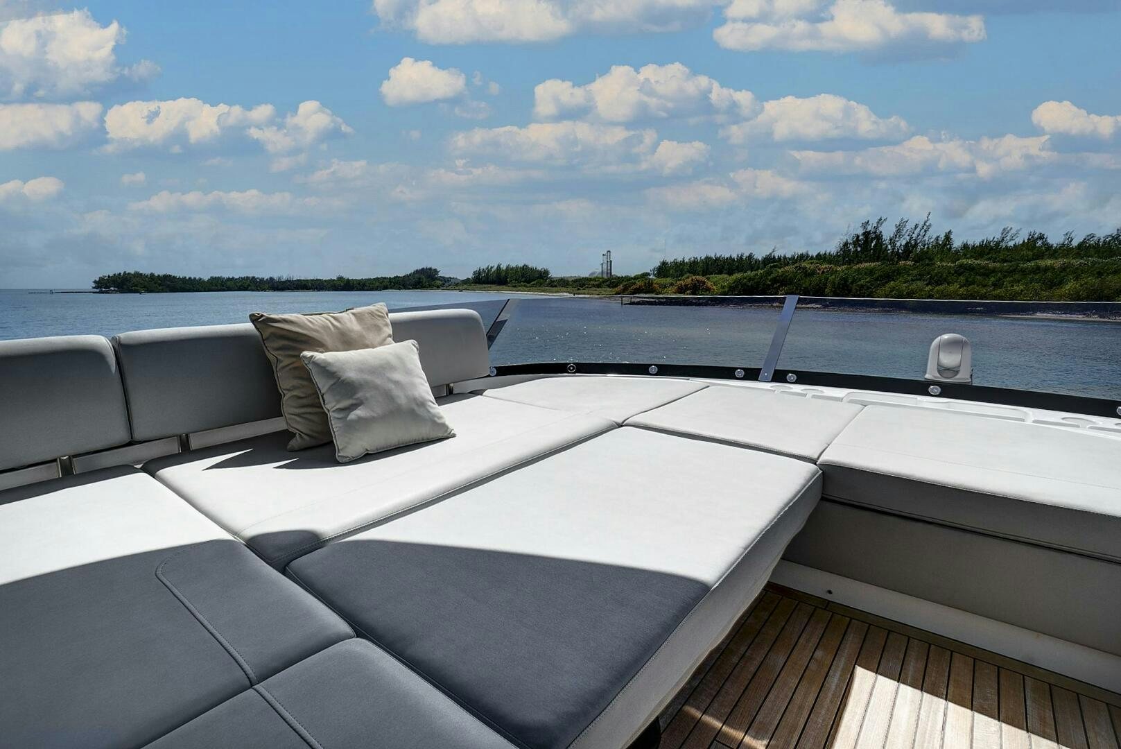 a deck with a view of a lake and trees aboard SEA ONE Yacht for Sale
