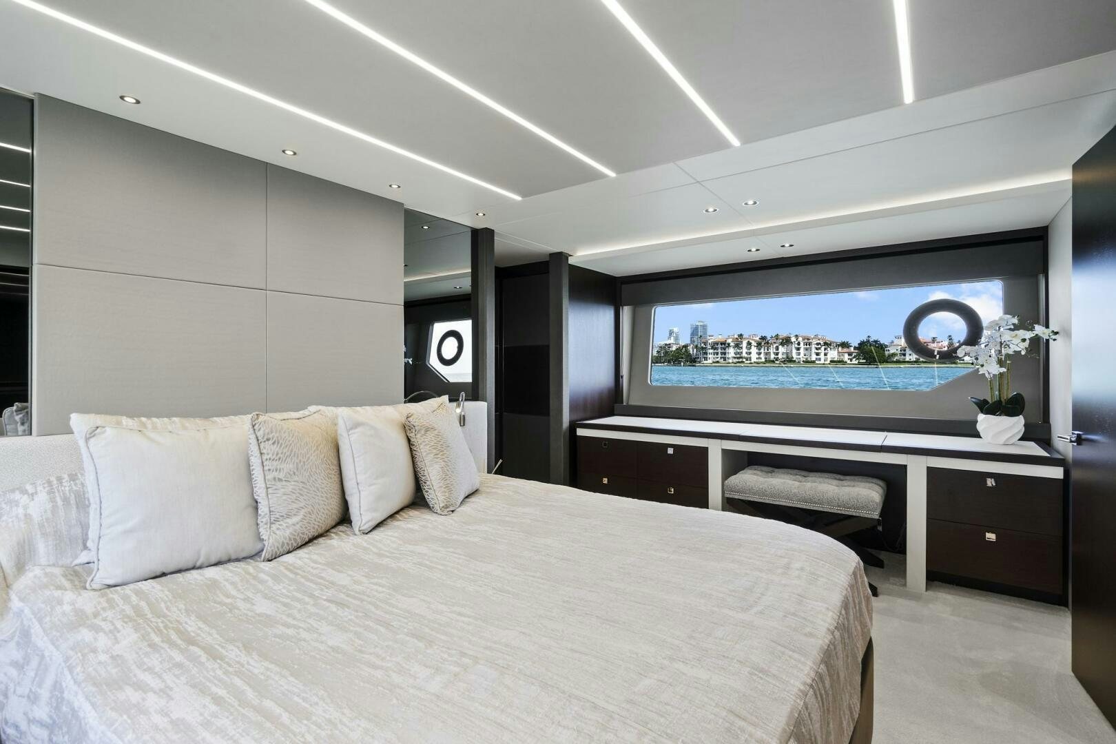 a modern bedroom with a large flat screen tv aboard SEA ONE Yacht for Sale