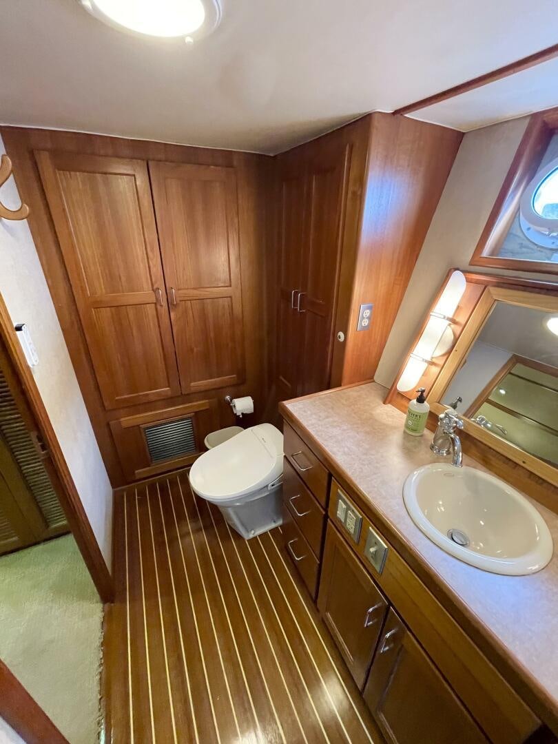 a bathroom with wooden cabinets aboard TRAVELLER II Yacht for Sale