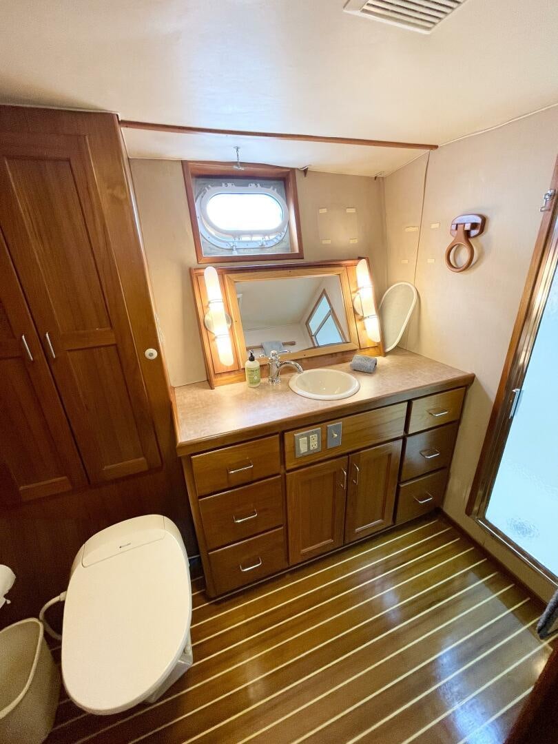 a bathroom with a sink and a mirror aboard TRAVELLER II Yacht for Sale