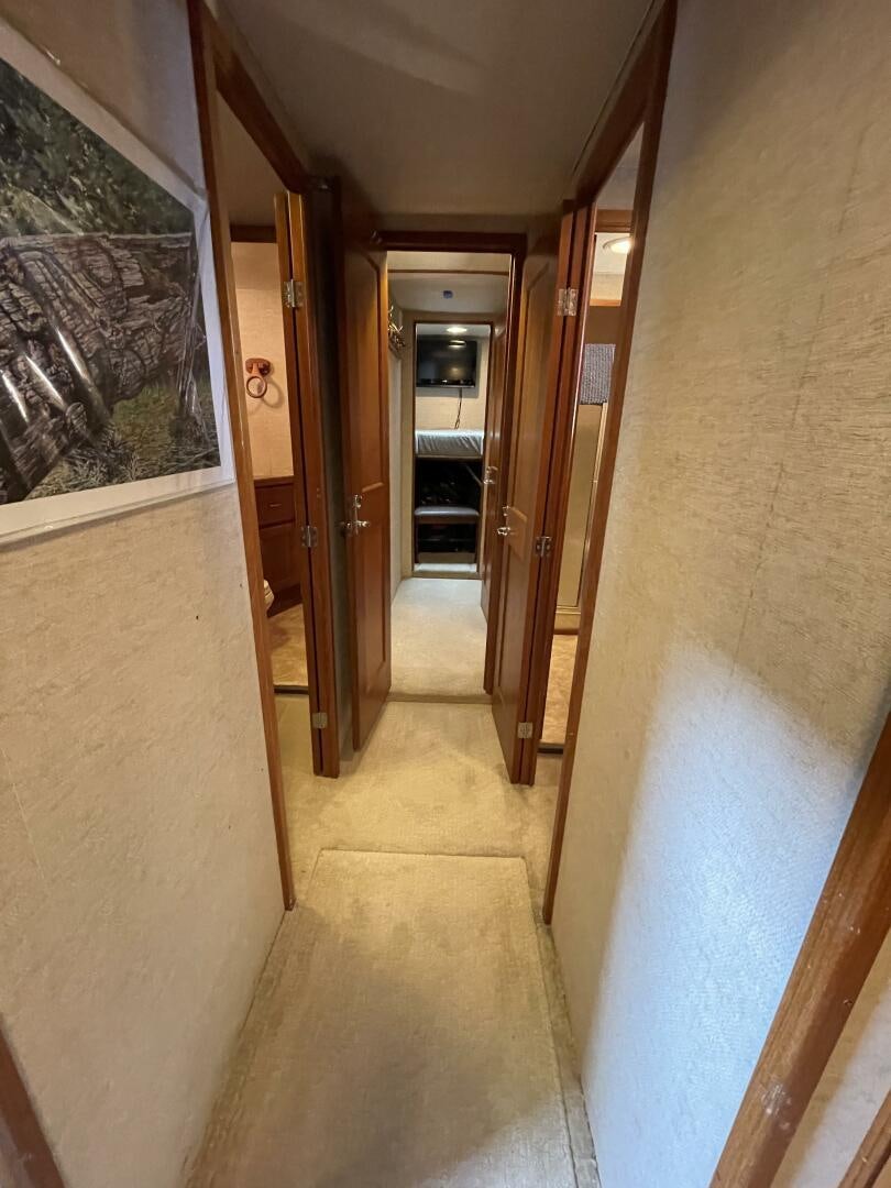 a hallway with a door and a painting on the wall aboard TRAVELLER II Yacht for Sale