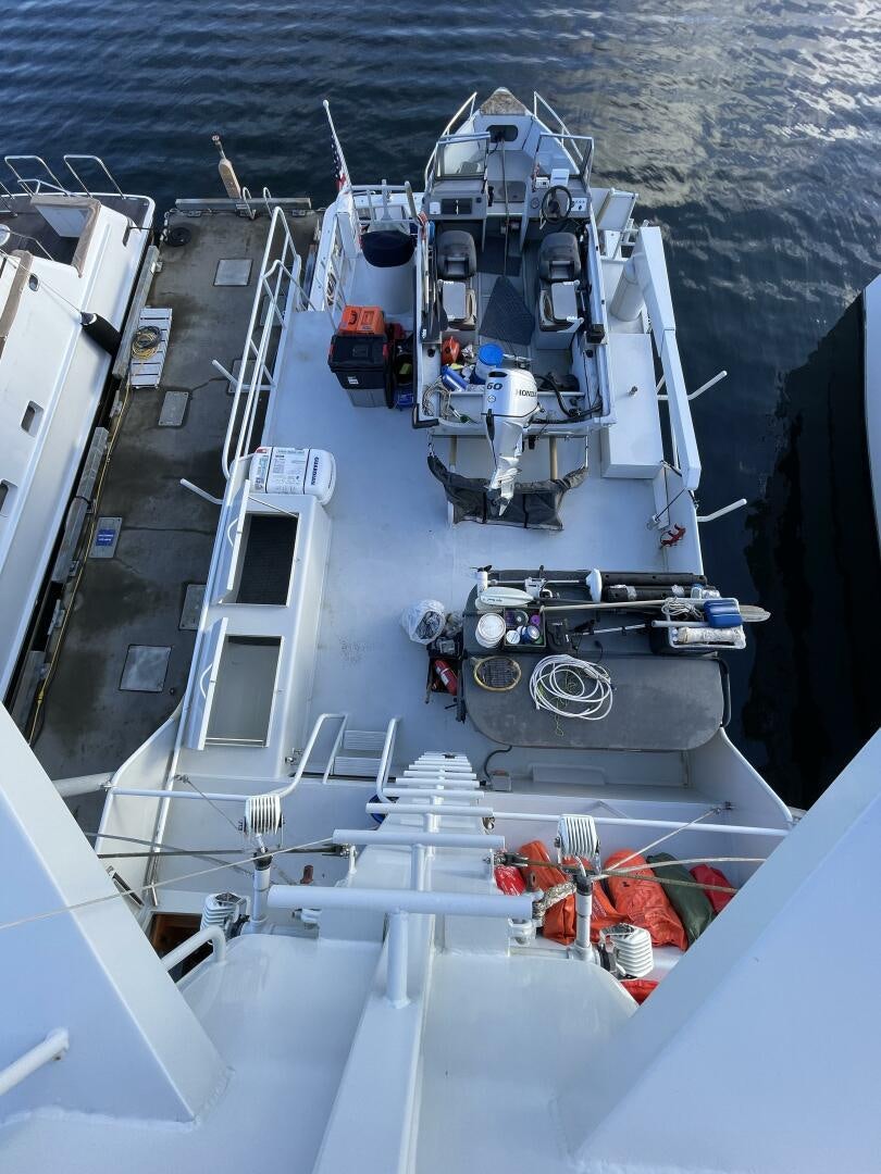 a large ship with a deck aboard TRAVELLER II Yacht for Sale