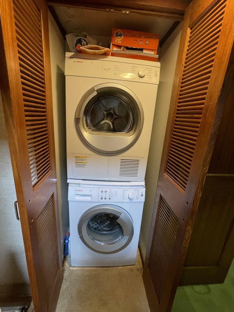 a dryer and dryer in a closet aboard TRAVELLER II Yacht for Sale