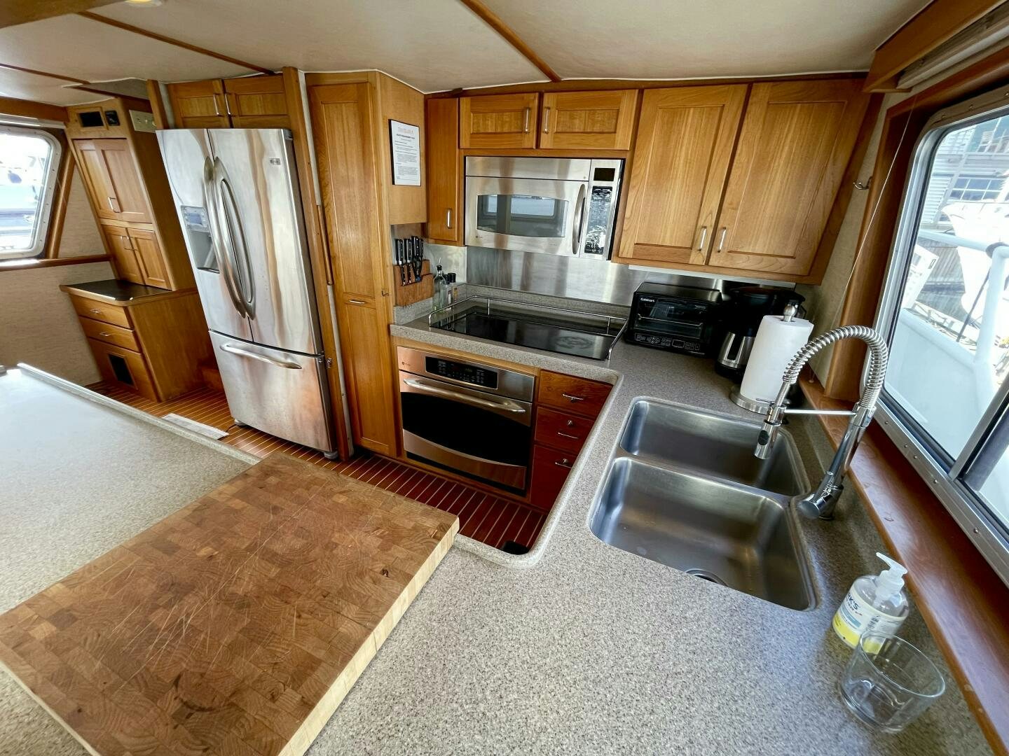 a kitchen with a stainless steel refrigerator aboard TRAVELLER II Yacht for Sale