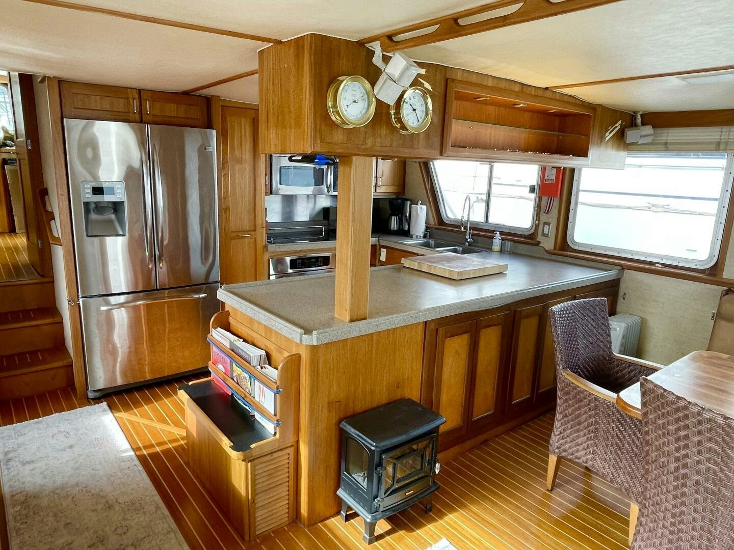 a kitchen with a bar and a refrigerator aboard TRAVELLER II Yacht for Sale