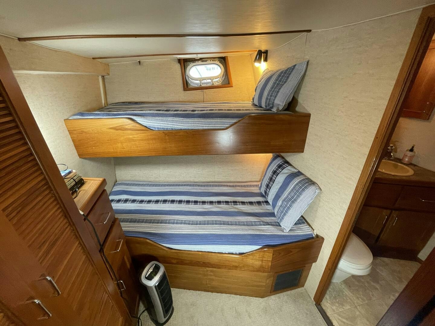 a bed with a wooden frame aboard TRAVELLER II Yacht for Sale