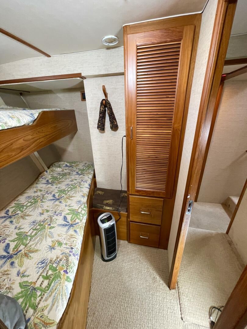 a bedroom with a closet and a bed aboard TRAVELLER II Yacht for Sale