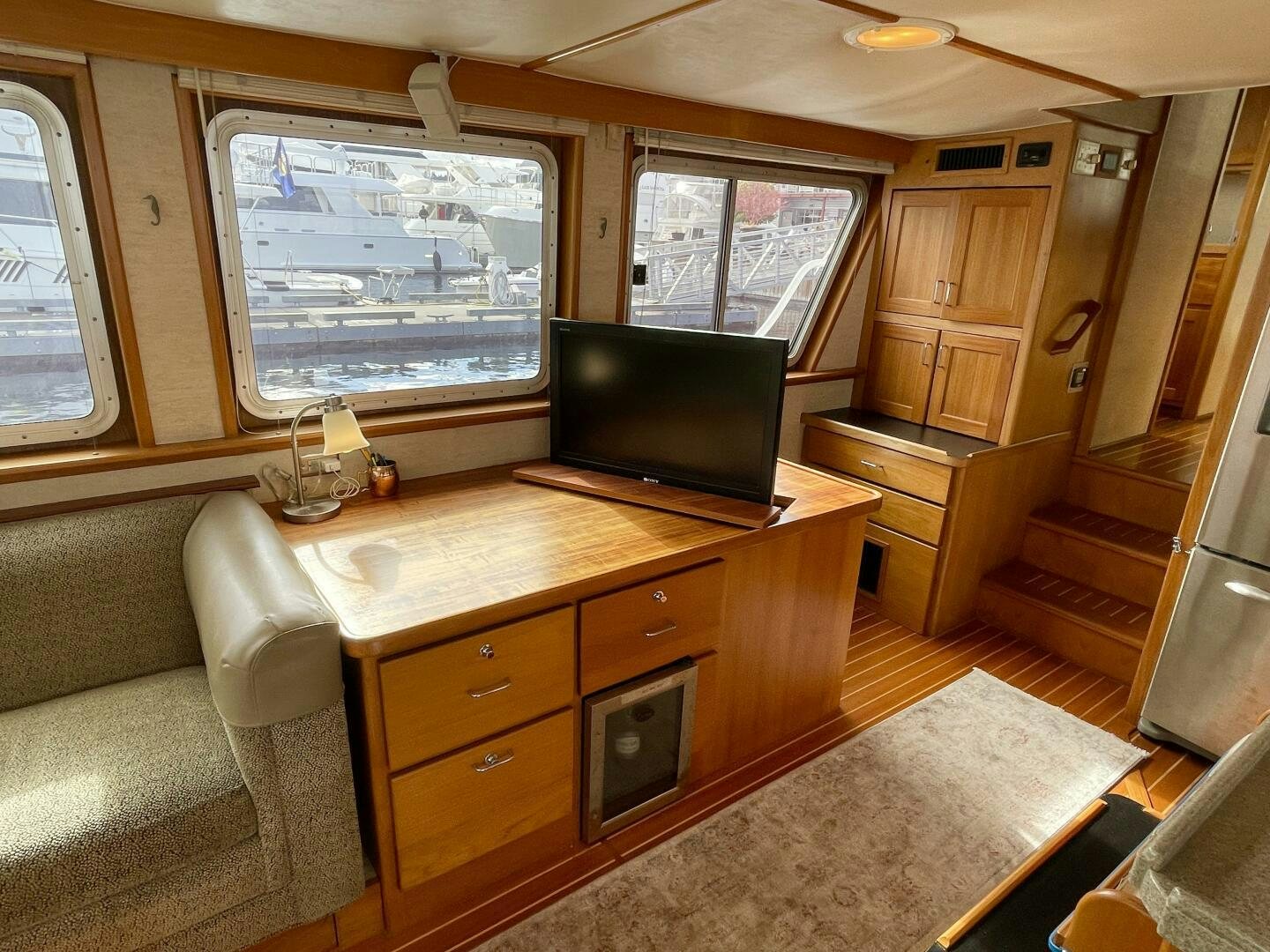 a living room with a tv and a desk aboard TRAVELLER II Yacht for Sale