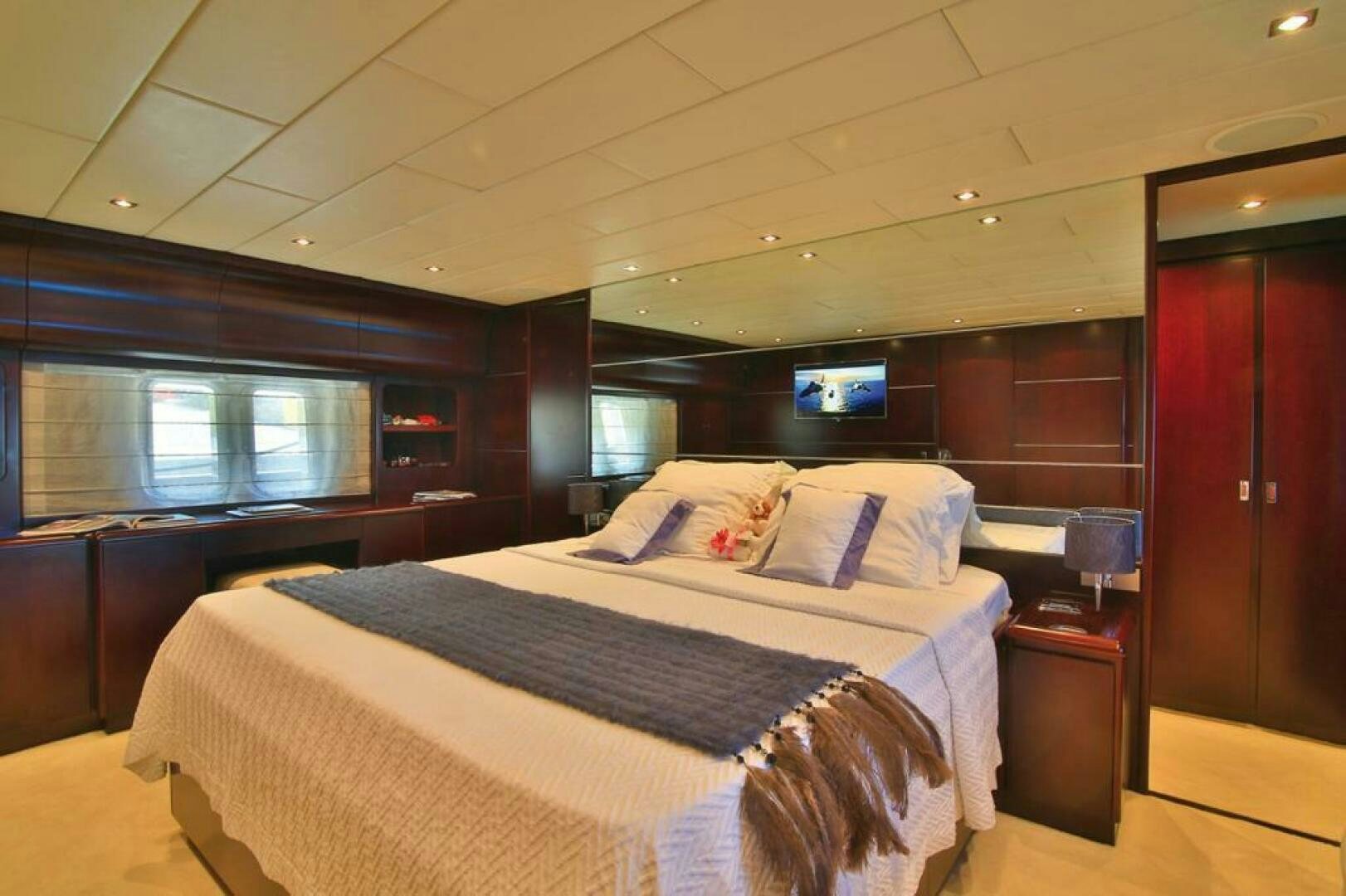 a room with a bed and a television aboard TENDER TO Yacht for Sale