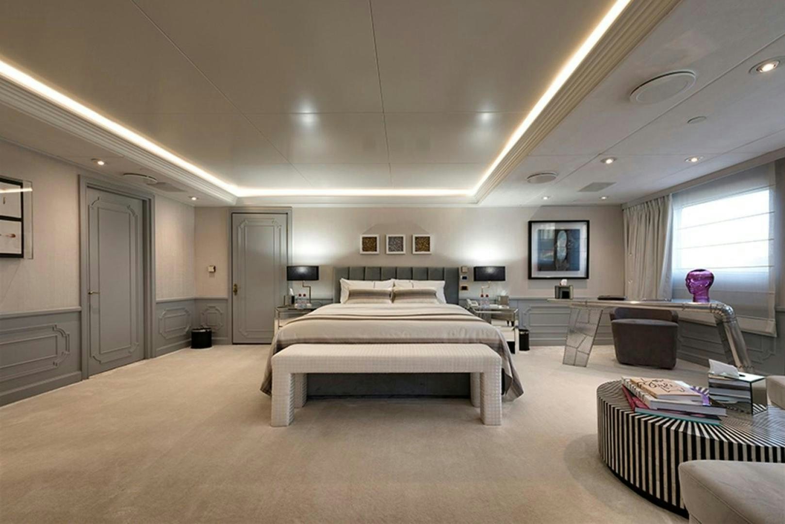 a large room with a bed and a desk aboard CHAKRA Yacht for Sale