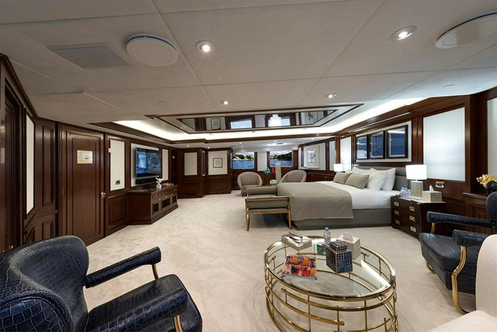 a living room with a couch and a television aboard CHAKRA Yacht for Sale