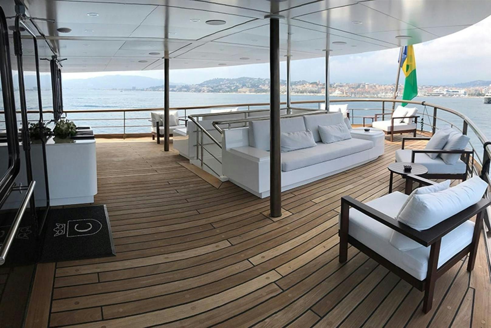 a deck with a couch and chairs aboard CHAKRA Yacht for Sale