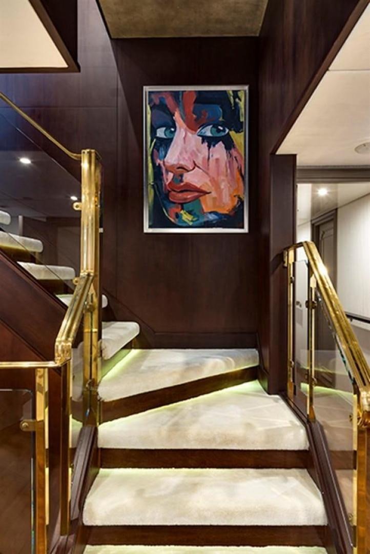 a bed with a painting on the wall aboard CHAKRA Yacht for Sale