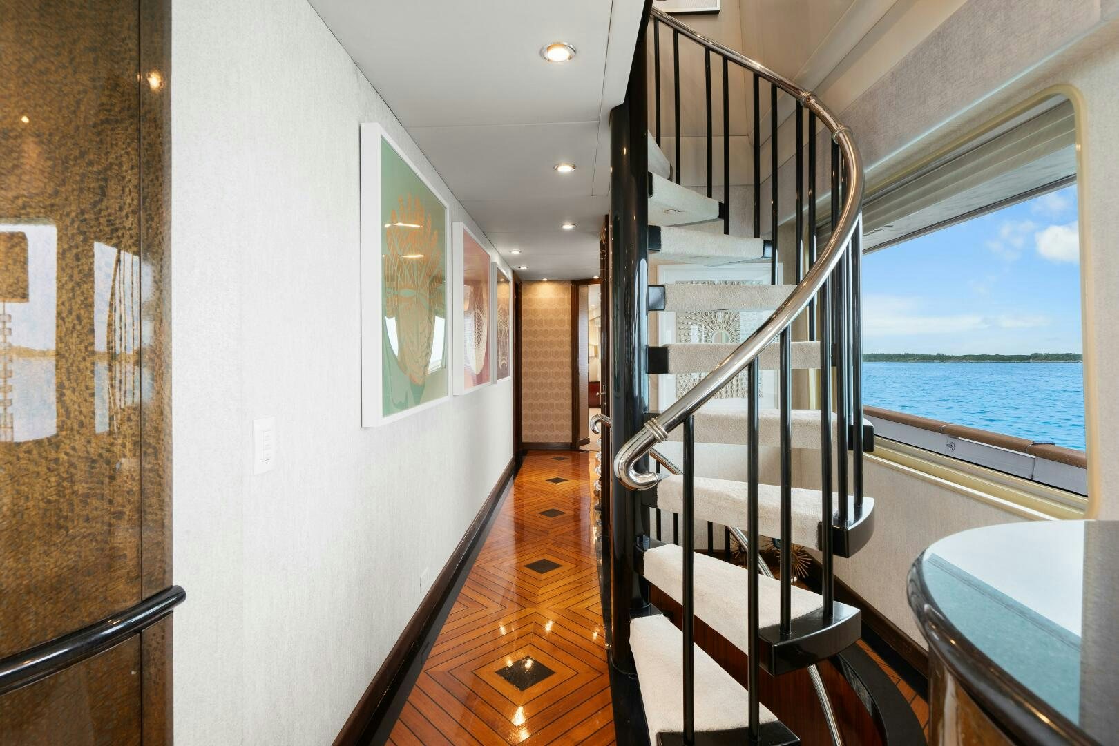 a room with a large window and a wood floor aboard SWEET ESCAPE Yacht for Sale