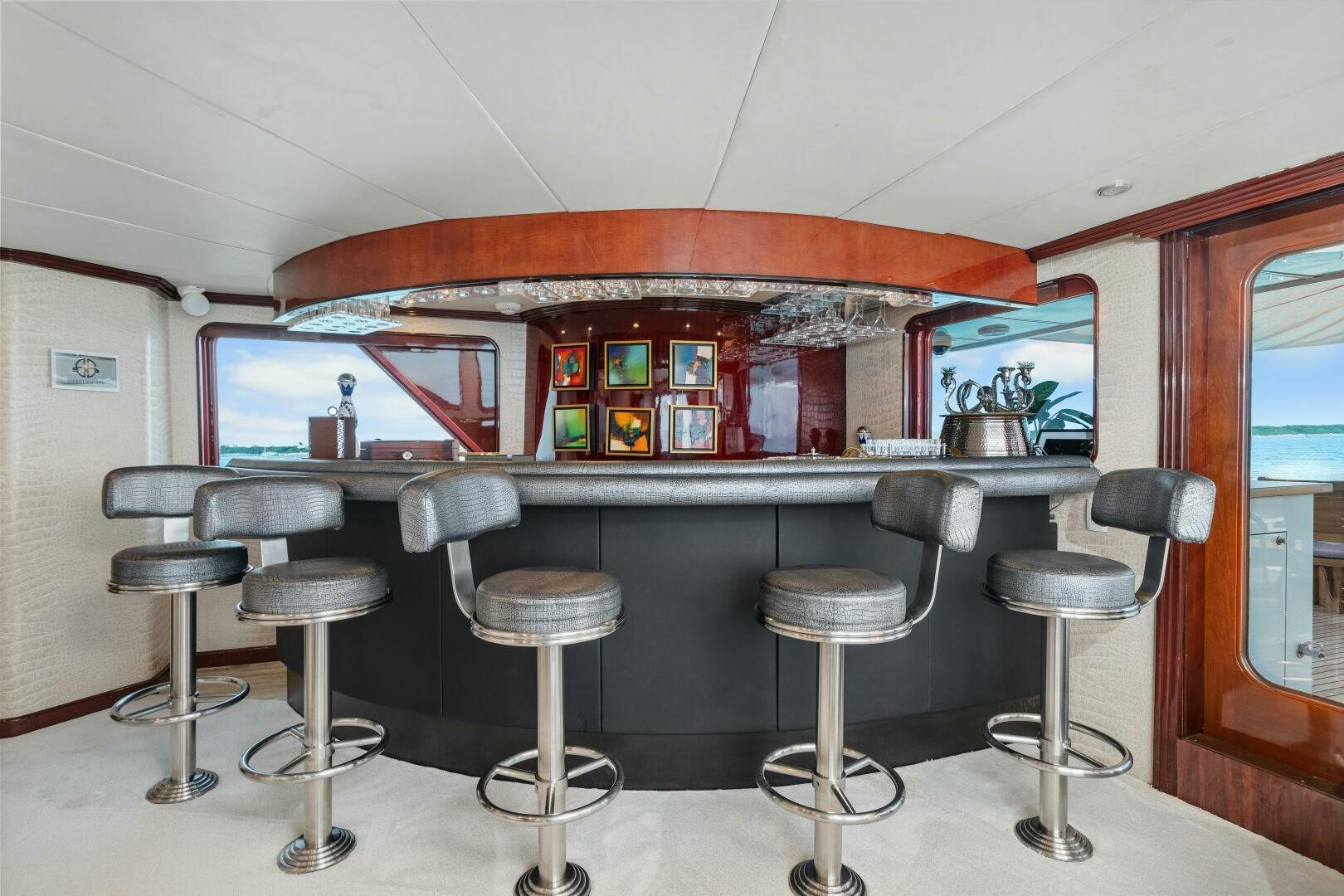 a bar with stools and stools aboard SWEET ESCAPE Yacht for Sale