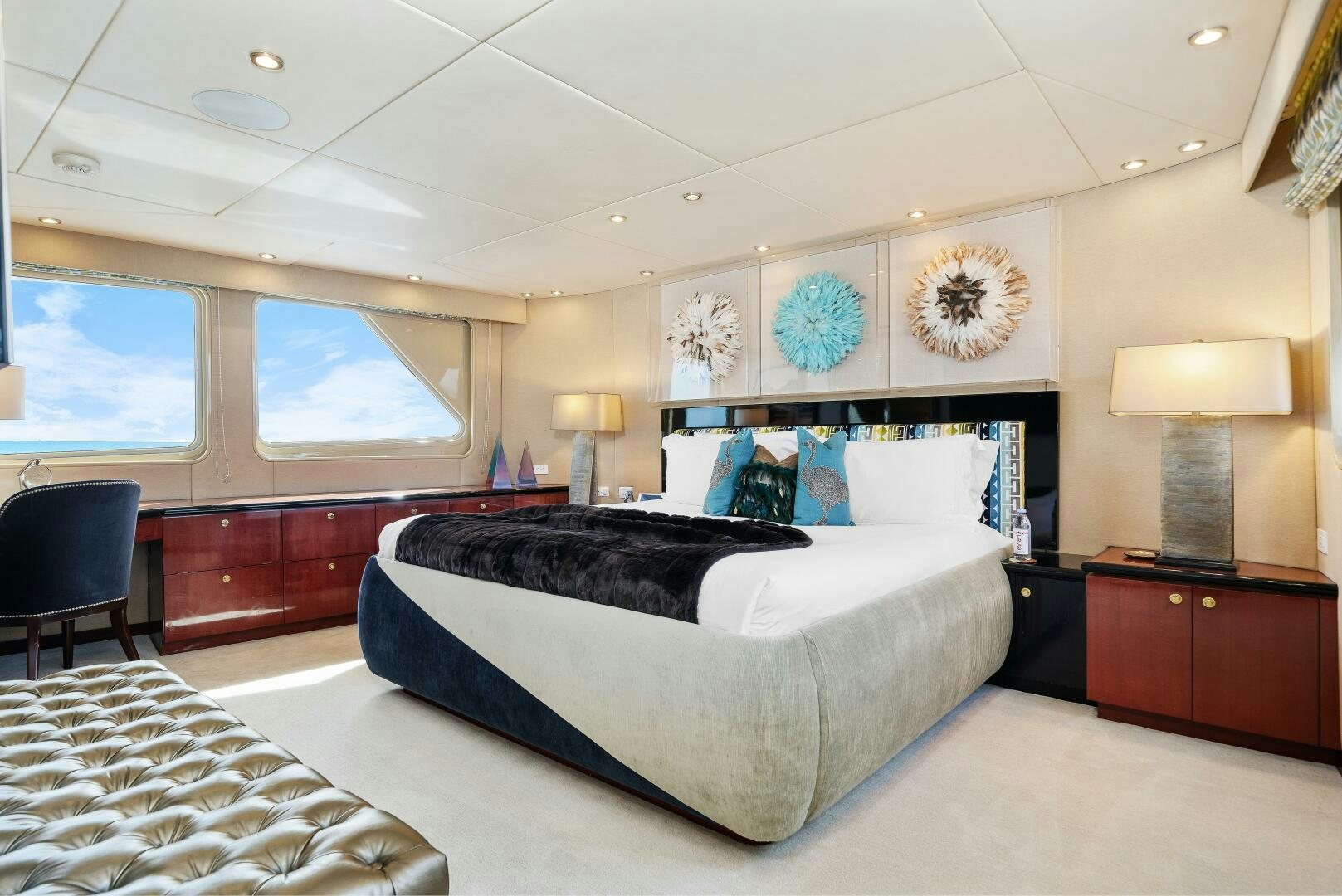 a bedroom with a bed and a desk aboard SWEET ESCAPE Yacht for Sale
