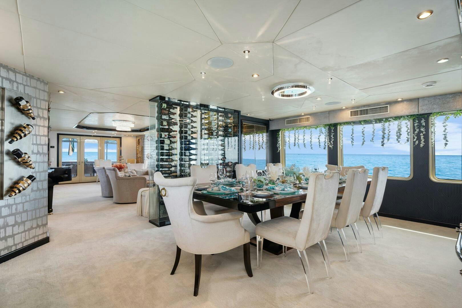 a room with tables and chairs aboard SWEET ESCAPE Yacht for Sale