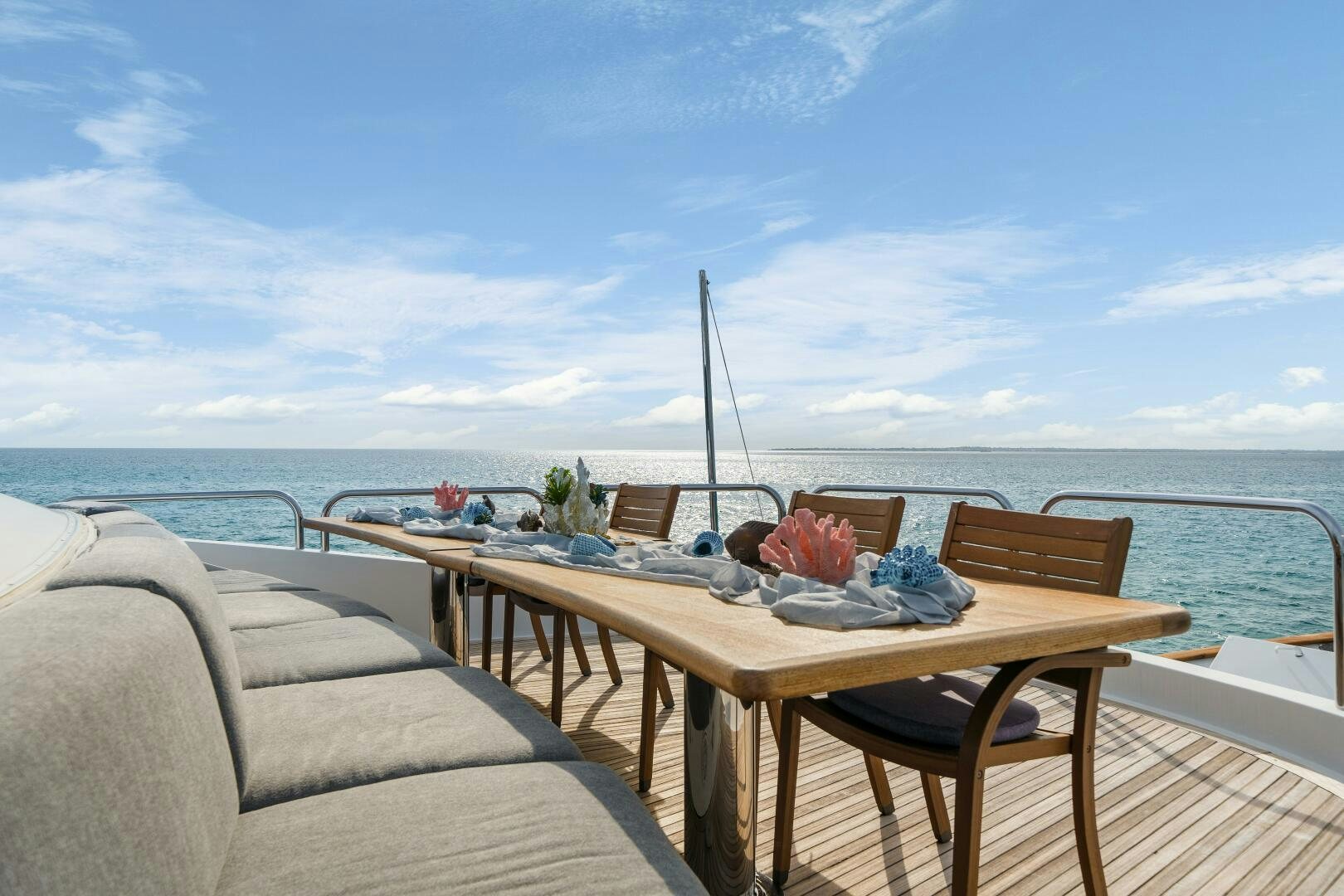 a table on a deck overlooking the ocean aboard SWEET ESCAPE Yacht for Sale