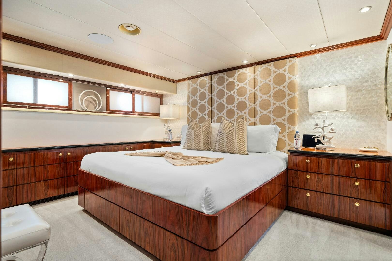 a bedroom with a bed and a lamp aboard SWEET ESCAPE Yacht for Sale