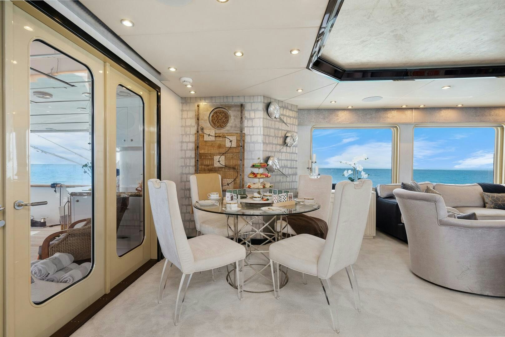 a room with a table chairs and a window aboard SWEET ESCAPE Yacht for Sale