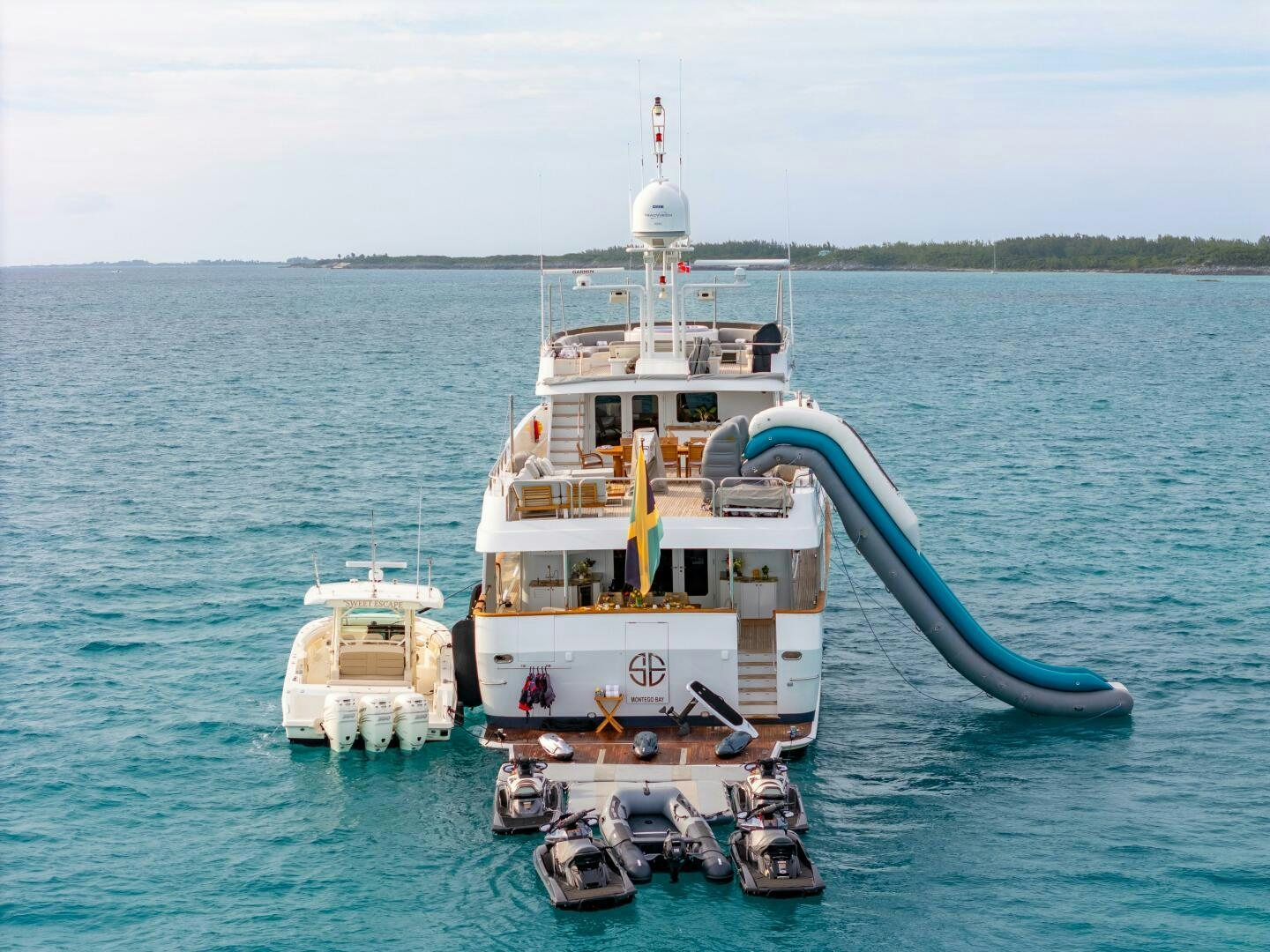 a boat with a crane on it aboard SWEET ESCAPE Yacht for Sale
